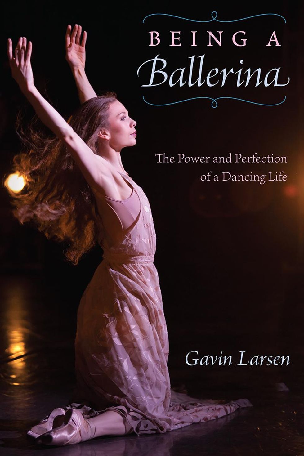 Gavin Larsen is shown onstage, kneeling in a pink dress and pointe shoes. Her long hair flows behind her as she raises her arms and looks out to the audience. The cover reads, "Being a Ballerina: The Power and Perfection of a Dancing Life. Gavin Larsen."