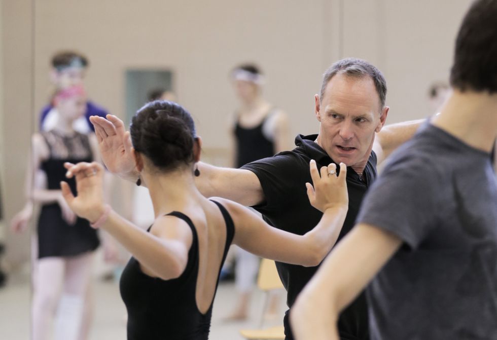 Brandsen demonstrating an arm movement for a dancer in rehearsal.