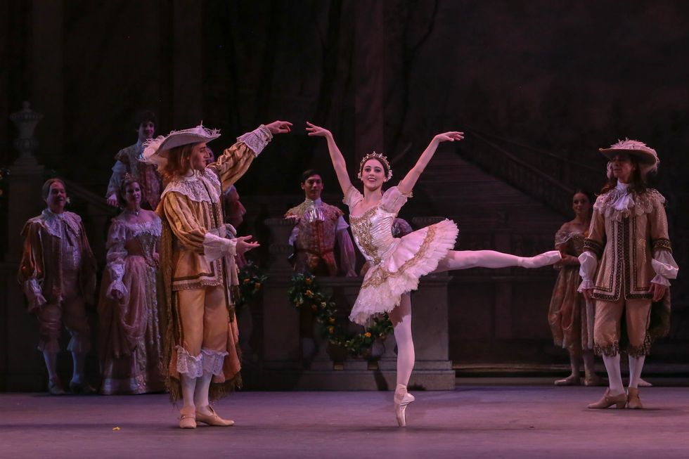 Barkman as Aurora during the Rose Adagio, in arabesque as one of her suitors stands next to her, gesturing to her.