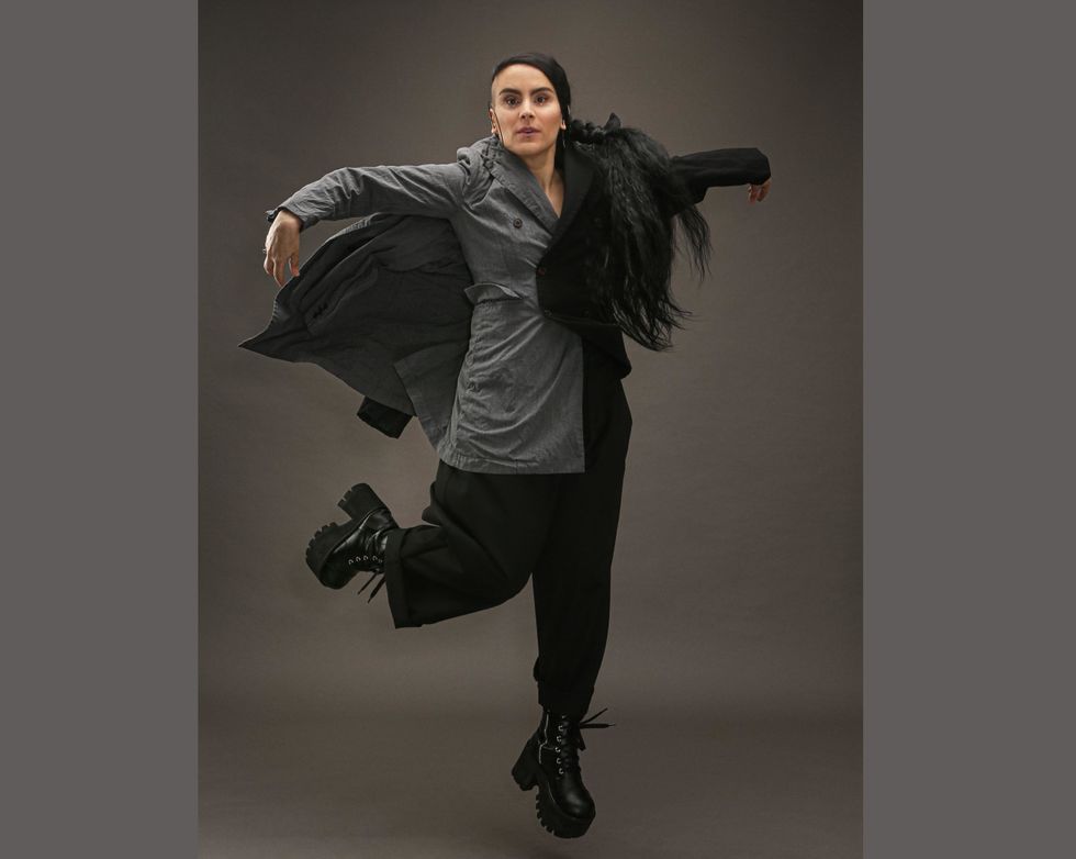 Sonya Tayeh jumps into the air with one leg bent