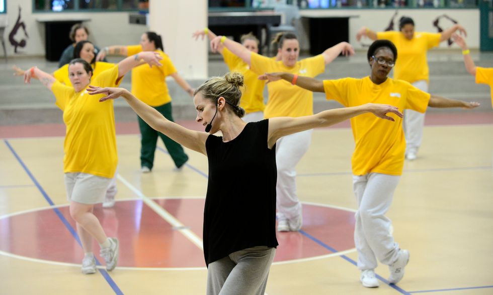 Lucy Wallace leads a Dance To Be Free class in a gym.