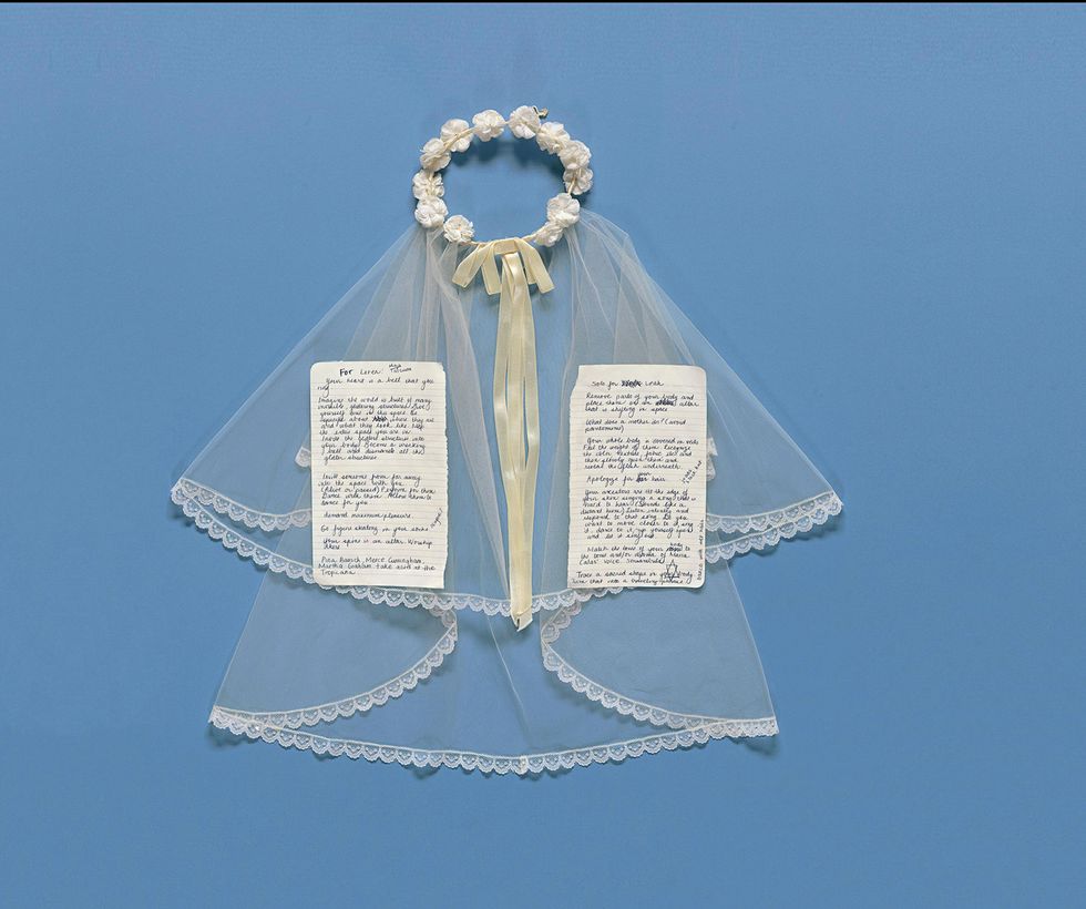 A communion vail and two handwritten pages from a notebook on a blue background