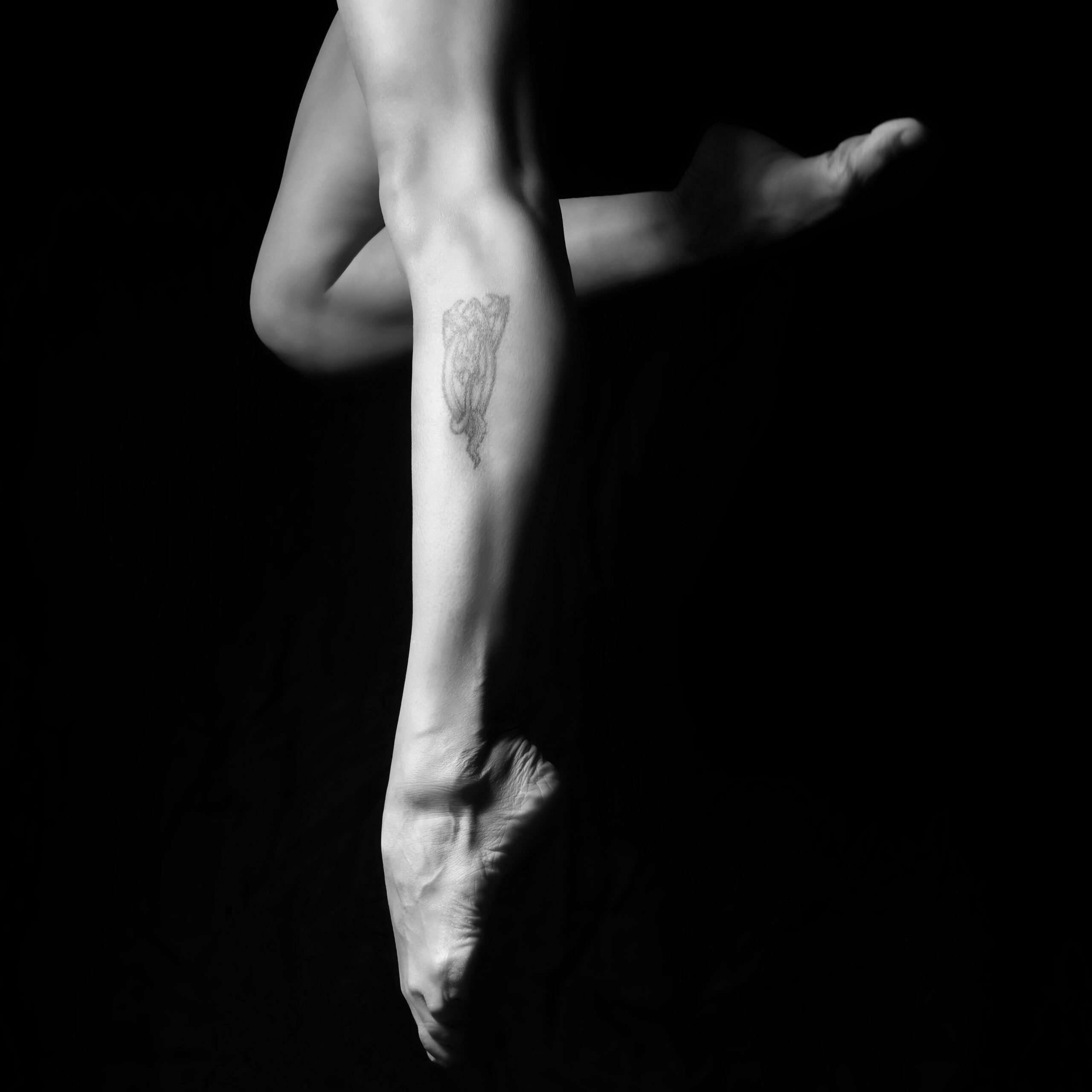 a dancer's foot pointing down as they jump