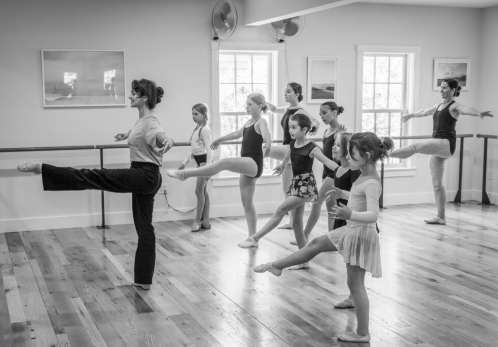 Lovette leads a ballet classroom full of students of various ages