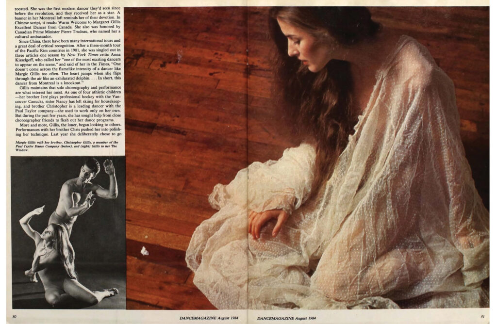 A spread from the August 1984 issue of Dance Magazine. Three quarters of the spread are taken up by a full color image of Gillis sitting on a wooden floor in a lacy white gown, brown curls tumbling around her shoulders, head bowed. At the bottom left is a black and white image of Gillis and her brother Christopher performing together, hands cupped in a manner reminiscent of Martha Graham. Article text is in the top right corner.