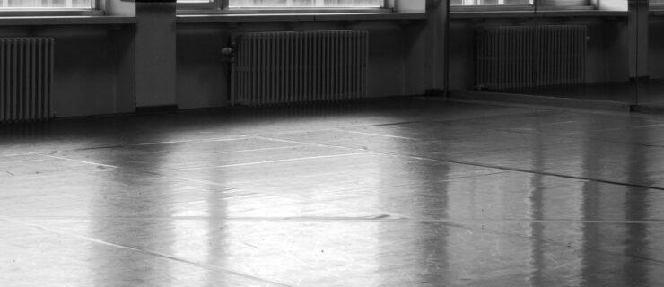 A black-and-white photo of an empty dance studio.