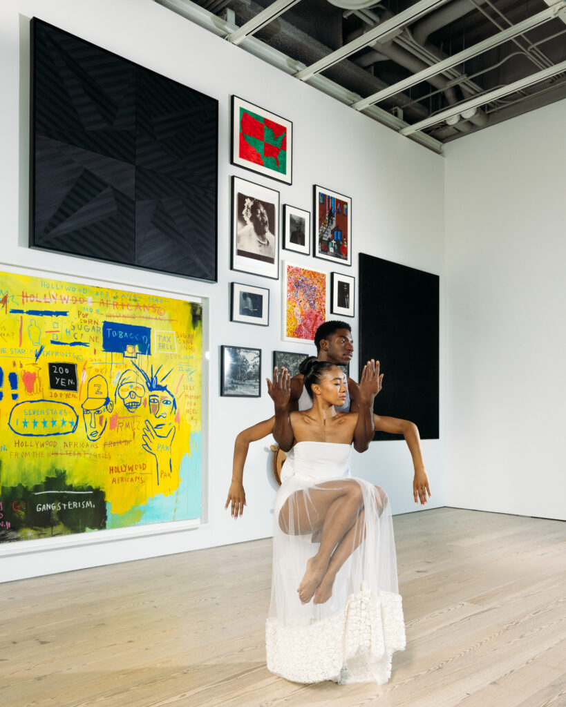 Isaiah Day holding Hannah Alissa Richardson in front of an art exhibit at the Whitney Museum.