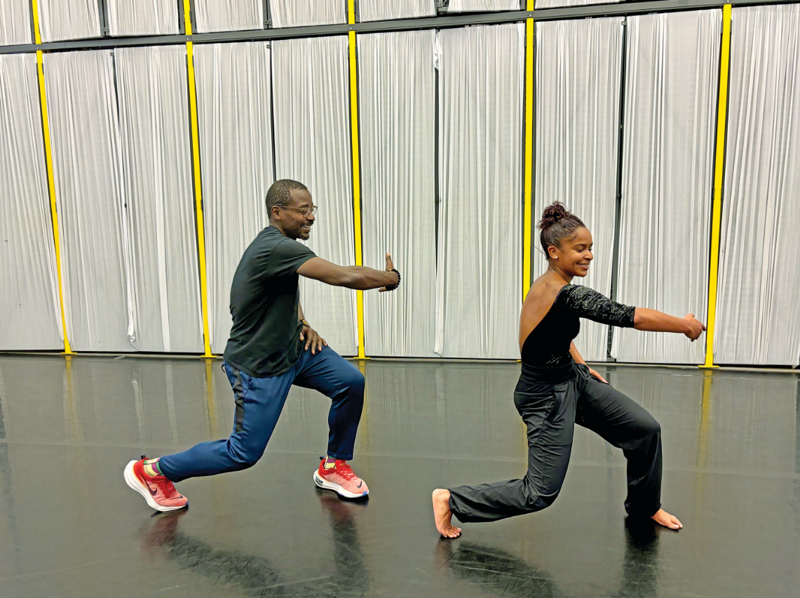 Robert Battle dancing next to Jada Pearman in rehearsal