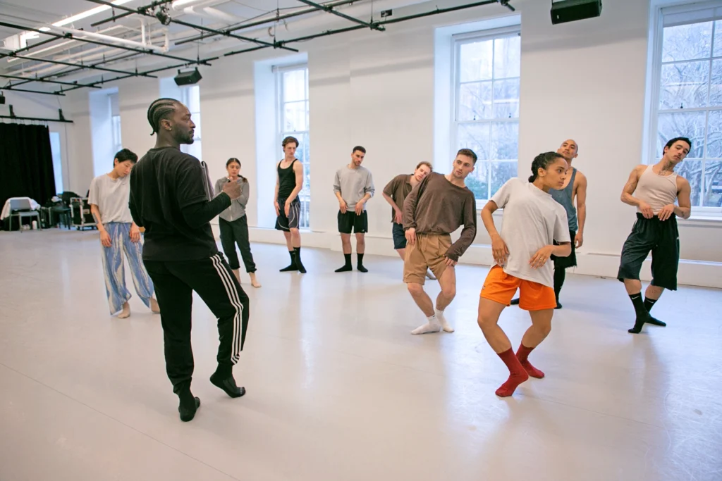 Gilbert T. Small II watches intently as a quartet of dancers move through an identical pose, which he lightly mirrors as he stands in front of them in the studio.