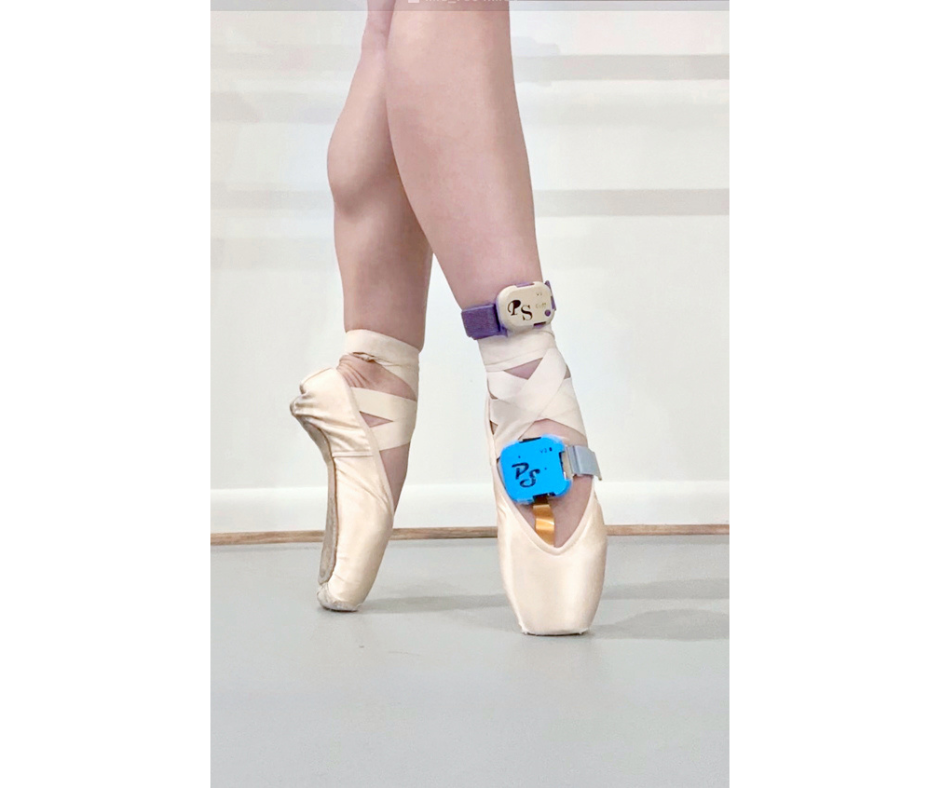 A close-up of a dancer's lower legs posed on pointe in a tight fourth position. The dancer wears a PointeSense biosensor on their right foot.