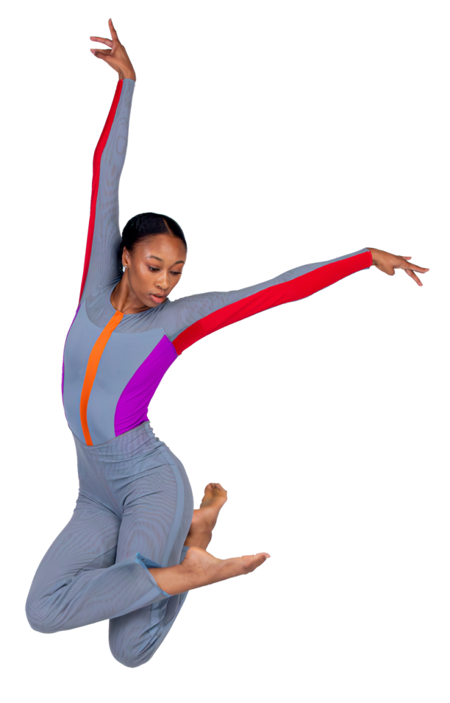 A dancer against a white backdrop is captured mid-jump, arms in an L and legs crossed and tucked up beneath her.