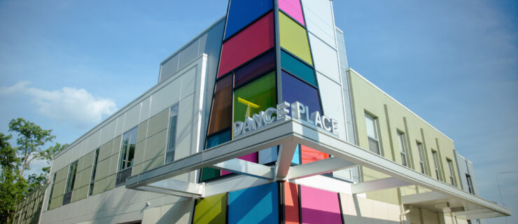 The Dance Place entrance photographed on a sunny day, with the building's signature colorful mosaic front and center.